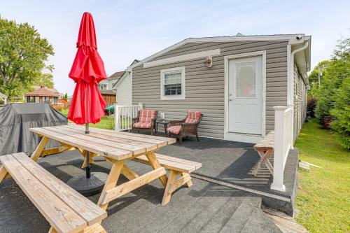 a picnic table with two umbrellas and a caravan at Dock, Deck and Fire Pit! Chautauqua Lake Retreat in Ashville