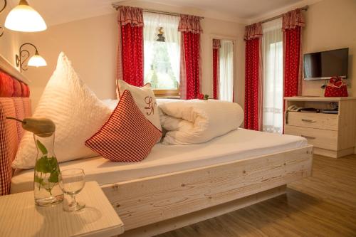 a living room with a bed with pillows on it at Landhaus Notburga in Gries im Sellrain