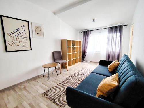 a living room with a blue couch and a table at Central houses budget friendly in Bucharest