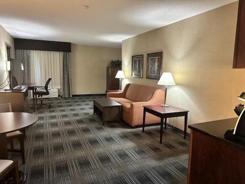 a hotel room with a couch and a table at Holiday Inn Express and Suites Meriden by IHG in Meriden