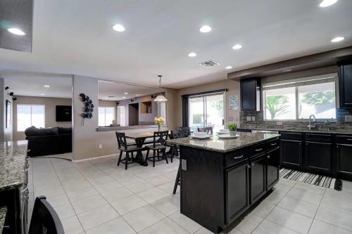 a kitchen and living room with a table and chairs at Spacious 5BR Retreat Pool Grill 15 Min to Westgate in Litchfield Park
