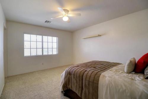 a bedroom with a bed and a ceiling fan at Spacious 5BR Retreat Pool Grill 15 Min to Westgate in Litchfield Park