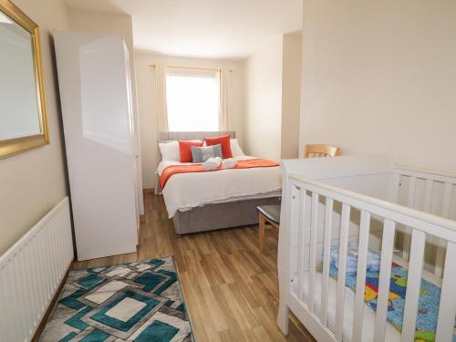a baby room with a crib and a bed at The Sperrin Getaway in Omagh