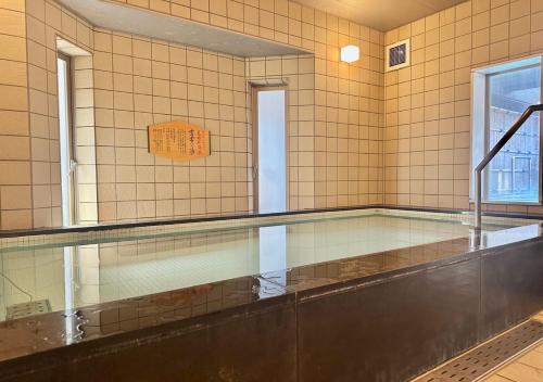 a bathroom with a large mirror on the wall at APA Hotel TKP Sapporo Eki-Kitaguchi Excellent in Sapporo