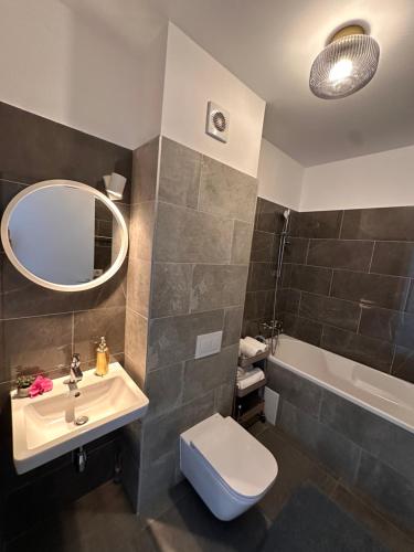 a bathroom with a sink and a toilet and a tub at Luxury Lavender Gorgeous Terrace Free UNDG Parking in Timişoara