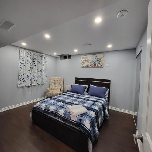 a bedroom with a bed and a chair in it at Cozy 2 Bedroom Suite, 5 mins from Thermea Spa in Whitby