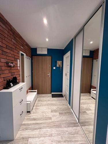 une grande salle de bain avec des murs bleus et un miroir dans l'établissement pawel i tomek, à Ostróda