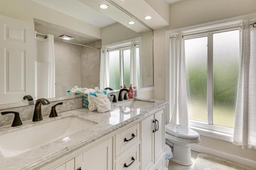 a bathroom with a sink and a toilet and a mirror at Waterfront Retreat with Boat Dock and Yard in Ft Myers in Iona