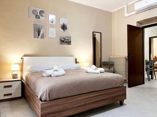 a bedroom with a bed with two towels on it at Maison DomInes in Ciampino