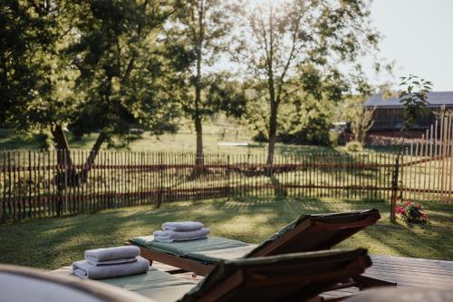 two towels are sitting on a table in a yard at Chalets am Duschl-Hof in Bayerbach