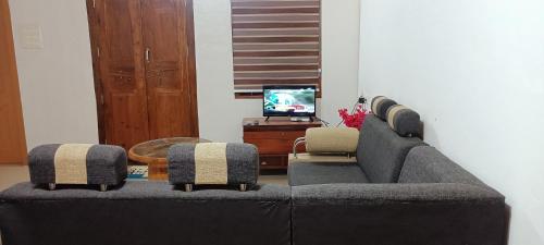 a living room with a couch and two chairs at River Soul Villa, Vagamon in Kattappana