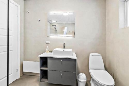 a bathroom with a white sink and a toilet at 2644 Nexø - Pilegårdsvejen 17 B in Neksø