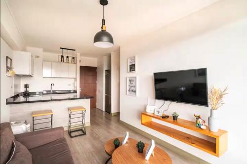 a living room with a large flat screen tv at Connect Apartment by Vibrant in Lima