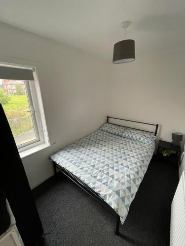 a bedroom with a bed in a room with a window at Modern 4 Bed Home, Free Parking in Hartlepool town in Hartlepool