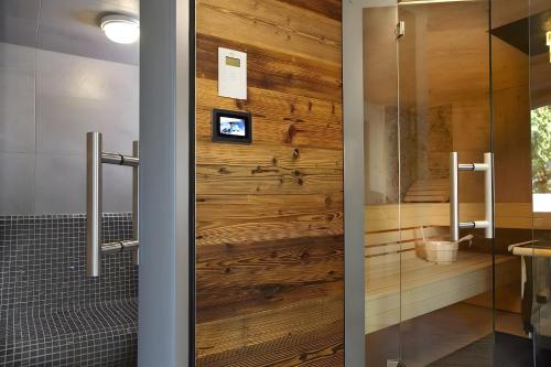 una puerta giratoria en un baño con una pared de madera en Hotzenwald, en Oberibach