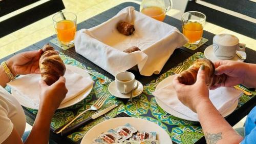 a group of people eating food on a table at Le Saline Rooms Marzamemi in Marzamemi