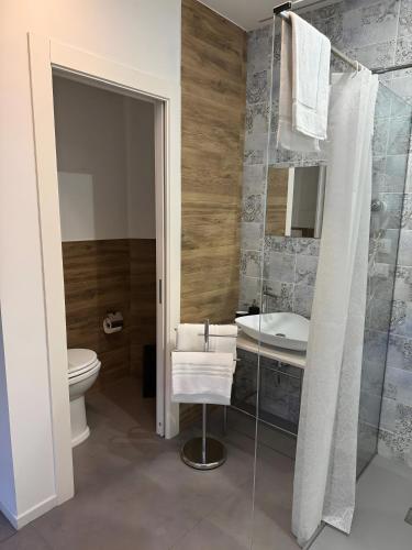 a bathroom with a sink and a toilet and a shower at Le Saline Rooms Marzamemi in Marzamemi