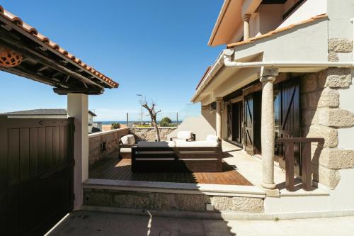a house with a gate and stairs to a house at Beach Villa with Jacuzzi & Garage by HostWise in Vila Chã