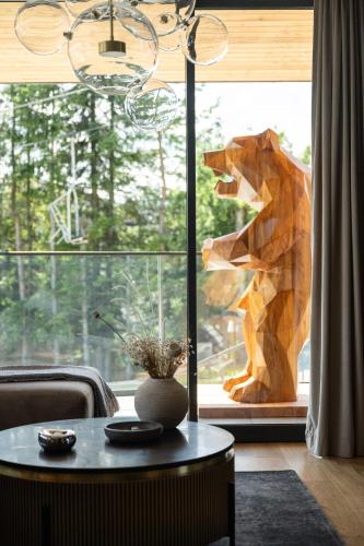 a statue of a dog standing in a window at Osada Gubałówka na Polanie Pająkówka & SPA in Kościelisko