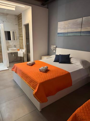 a bedroom with a bed with two towels on it at Le Saline Rooms Marzamemi in Marzamemi