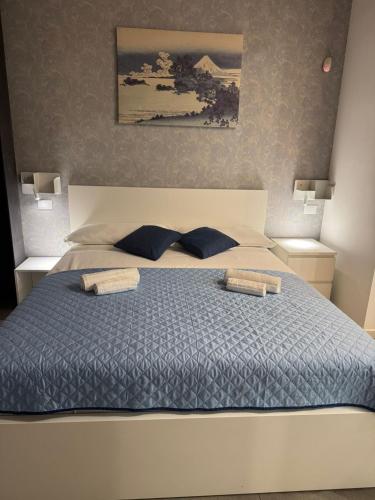 a bedroom with a large bed with two pillows at Le Saline Rooms Marzamemi in Marzamemi