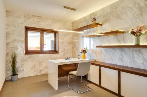 a bathroom with a sink and a desk in it at Beach Villa with Jacuzzi & Garage by HostWise in Vila Chã