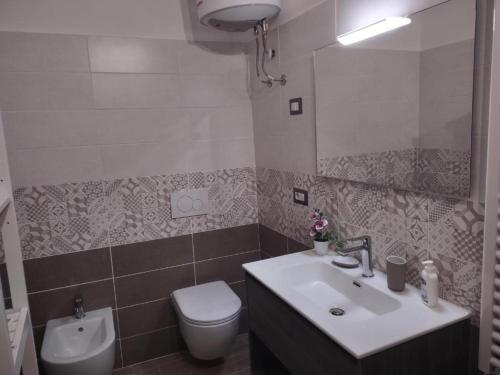a bathroom with a sink and a toilet at Affittacamere Da Riccardo in Jerzu