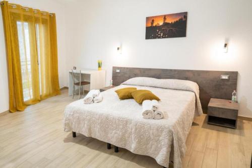 a bedroom with a bed with towels on it at Affittacamere Da Riccardo in Jerzu
