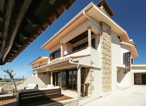 a villa with a view of the house at Beach Villa with Jacuzzi & Garage by HostWise in Vila Chã