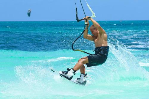 a man is on a board in the water at Ocean Majesty in Playa Blanca