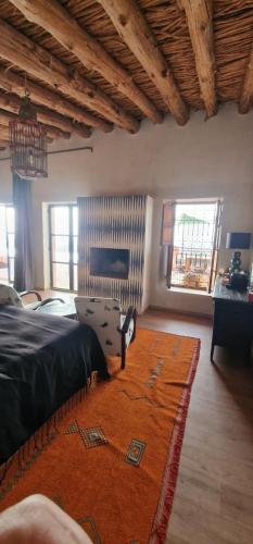 a living room with a bed and a rug at Dar Imiri in Ourika