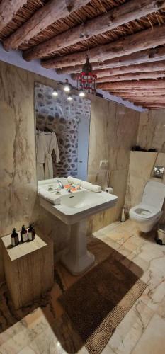 a bathroom with a sink and a toilet and a mirror at Dar Imiri in Ourika