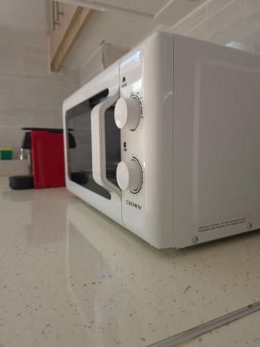 a white toaster sitting on top of a counter at Cloud9Rest & Fly in Koropíon