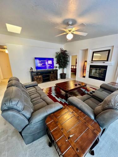 a living room with couches and a table and a tv at Large Prescott Home with 3-car Garage Central & Quiet in Prescott