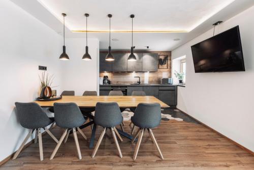 a kitchen and dining room with a wooden table and chairs at Apart Walser in Seefeld in Tirol