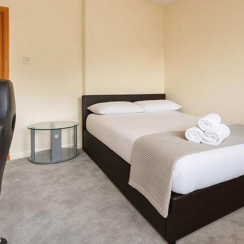 a hotel room with two beds with towels on them at Bright & Spacious 2 Bedroom Flat in Edinburgh