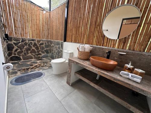 a bathroom with a wooden sink and a mirror at Wayma House in Villeta