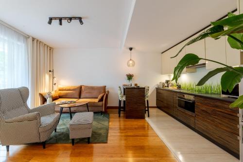 a living room with a couch and a tv at BATOREGO FLATS No 13 Pszczyna - Walk to Castle - Apartment with Parking, Balcony, Elevator, Fast WiFi in Pszczyna