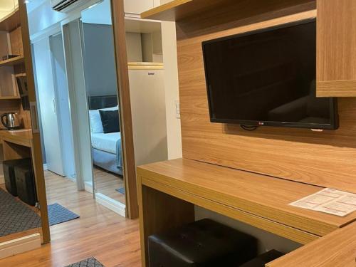 a flat screen tv on a wall in a room at Flat Parque do Ibirapuera - Jardins in Sao Paulo