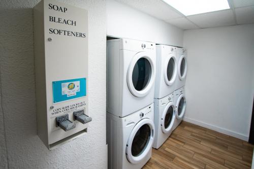 two washing machines are in a laundry room at Bay Club of Sandestin in Destin