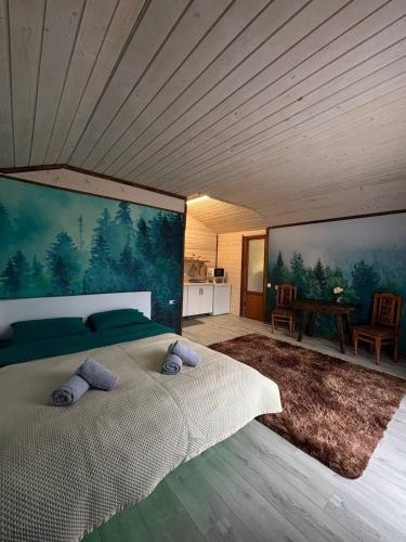 a bedroom with a bed with two pillows on it at Fox home in Khashchovanoye