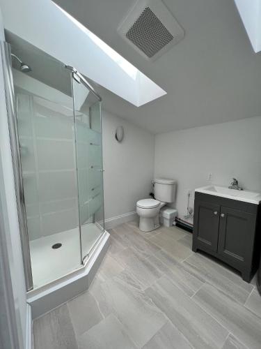 a bathroom with a shower and a toilet and a sink at Unique private room and bath in Halifax