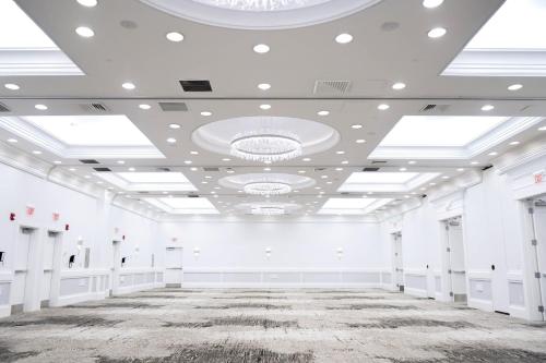 a large room with white walls and a ceiling with skylights at Crowne Plaza Providence-Warwick (Airport) by IHG in Warwick