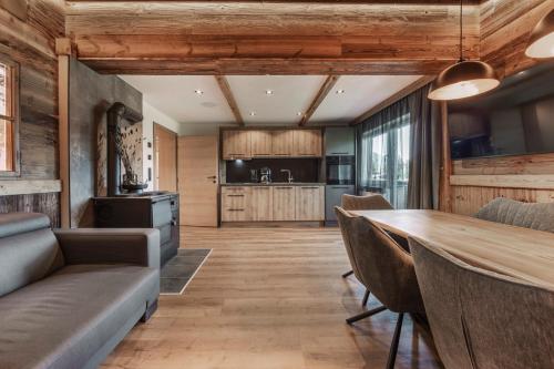 a kitchen and dining room with a table and chairs at Apart Walser in Seefeld in Tirol