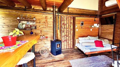 Un dormitorio con una cama y una estufa en una habitación. en Gaia Cabanas - Urubici - Terra, en Mundo Novo