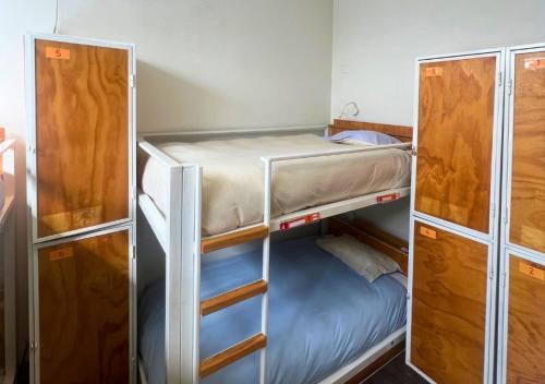 a room with two bunk beds and a bed at The Hostel Santiago in Santiago