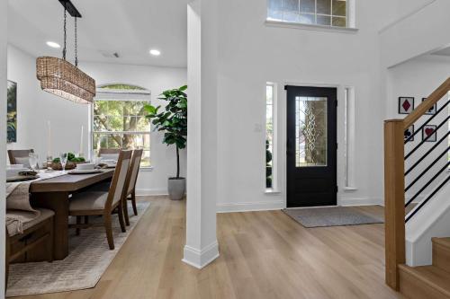 a dining room and living room with a dining room table at Heated Pool & Spa Mini Golf Bowling Game Room perfect for family in Rockwall
