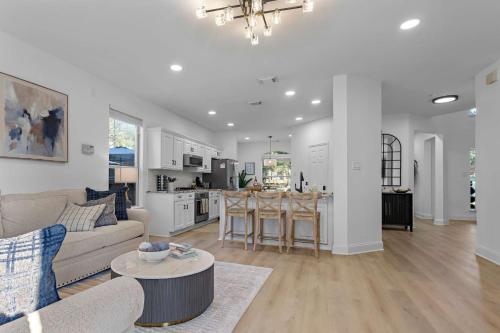 a living room and kitchen with a couch and a table at Heated Pool & Spa Mini Golf Bowling Game Room perfect for family in Rockwall