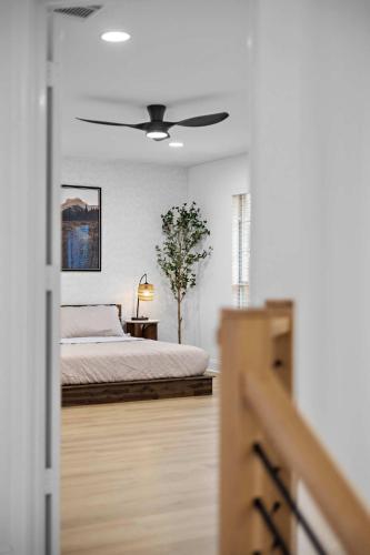 a bedroom with a bed and a ceiling fan at Heated Pool & Spa Mini Golf Bowling Game Room perfect for family in Rockwall