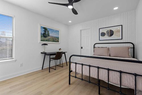 a bedroom with a bed and a desk at Heated Pool & Spa Mini Golf Bowling Game Room perfect for family in Rockwall
